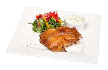 roasted chicken with vegetables on a white plate