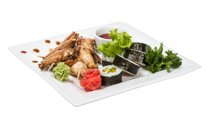 Buffalo chicken wings on plate with sushi