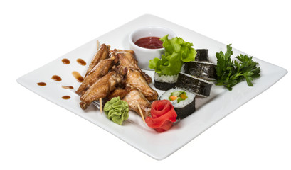 Buffalo chicken wings on plate with sushi