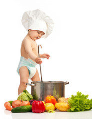 Little boy in chef's hat with ladle, casserole, and vegetables