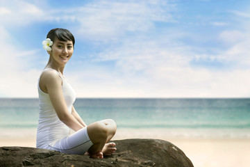 Fototapeta na wymiar Young Asian Woman Smiling at Beach