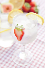 cocktail with ice,lemon, fig and strawberries on a plate