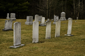 Five tombstones in a graveyard.