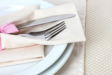 Table setting with fork, knife, plates, and napkin
