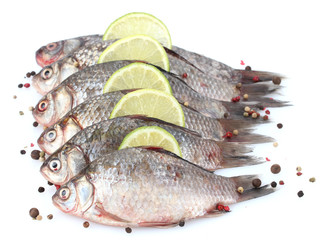 Fresh fishes with lime and spice isolated on white