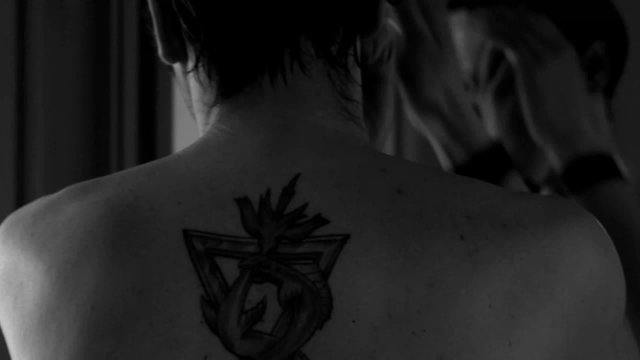 Man with tattoo fixing his hair, slow