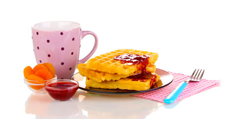 Tasty waffles with jam on plate isolated on white