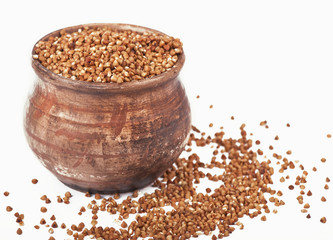 raw buckwheat in bowl isolated on white