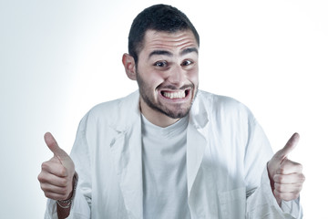 Young researcher wearing a labcoat smiling and with thumbs up