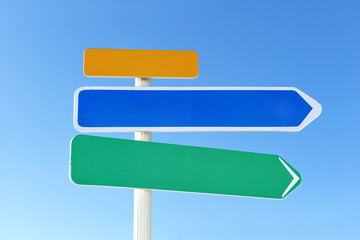 Arrow sign against sky