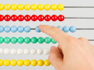 A man using an abacus on a white background