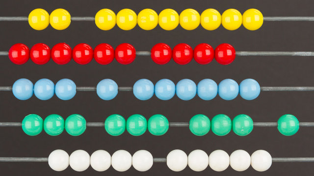 Close-up of an abacus on a grey background