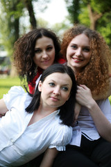 Portrait of three girls posing in the park