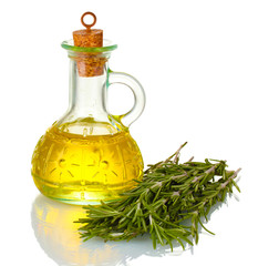 Oil in a bottle and fresh rosemary isolated on white