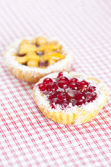 beautiful cake with berries on plaid fabric