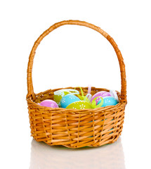 Fototapeta na wymiar Colorful easter eggs in basket isolated on white