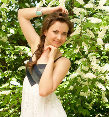 Beautiful woman in spring white flowers