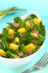 Fresh watercress, pineapple and ham salad in bowl
