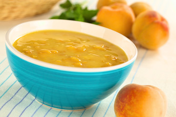 Refreshing cold peach soup in blue bowl