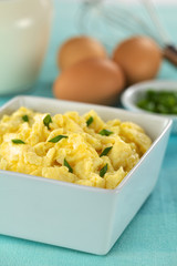 Scrambled eggs with green onion in bowl