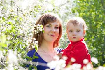 mother and baby  in blossoming garden