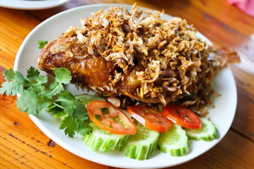 Fried fish served with tomato, cucumber.