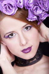 Naklejka premium Portrait of beautiful redhead girl with style make-up and flower