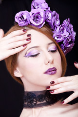 Portrait of beautiful redhead girl with style make-up and flower