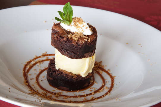 Excellent brownies with ice cream on a white plate