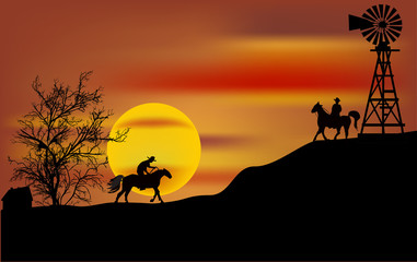 two cowboys at orange sunset