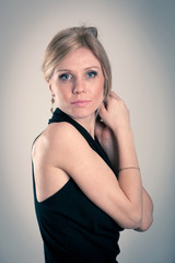 Beautiful blonde caucasian woman with elegant black dress.