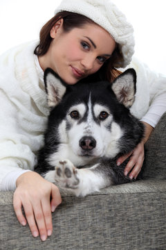 Portrait of a young woman with husky