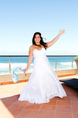 Fototapeta na wymiar cheerful young bride on balcony