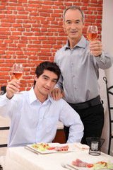 Man with his grandson eating in a restaurant