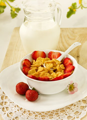 strawberries and corn flakes in a white cup