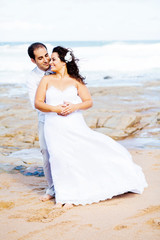 Fototapeta na wymiar romantic groom and bride portrait on beach