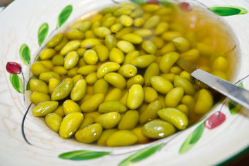 Green olives at restaurant's brunch  in decorated plate
