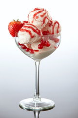 Ice cream with fresh berries and strawberry sauce