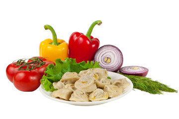 Tasty pelmeni with tomato and salad