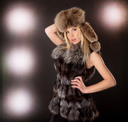 portrait of a beautiful blond woman wearing fur coat and hat