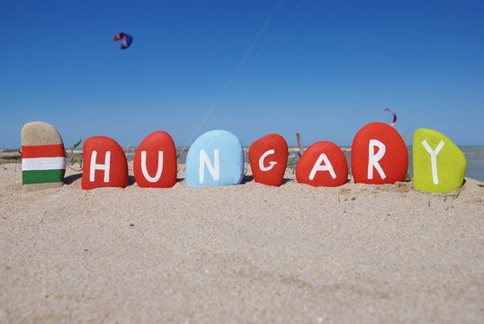 Hungary on colourful stones with flag on the beach
