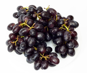 Bunch of black grapes isolated on white background