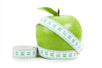 fresh apple with measuring tape. isolated over white background