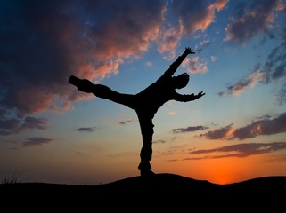 man doing an exercise on a evening sky background
