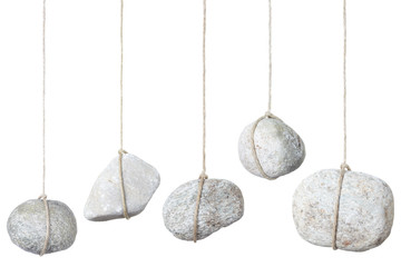 Stone hanging by a string on white, clipping path included