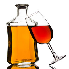 Cognac bottle and glass isolated on white