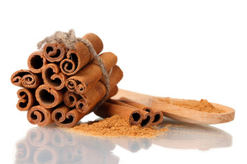Cinnamon sticks and powder in wooden spoon isolated on white