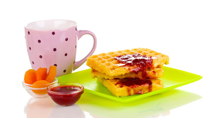 Tasty waffles with jam on plate isolated on white
