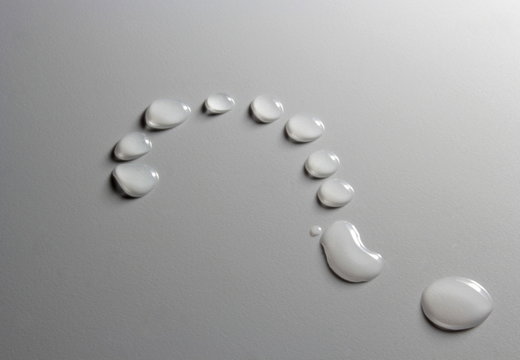 Water drops question mark on grey background
