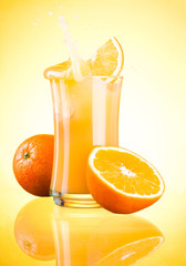 Splashing Fresh Orange Juice on yellow background